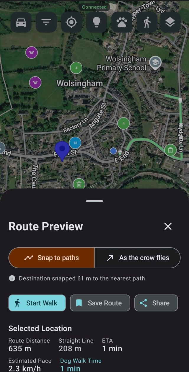 The WoofWalk app on a phone: a green walking route snapped to footpaths across a satellite map, dog-waste bins pinned along it, and a panel reading Route Distance 635 m, Straight Line 208 m, ETA 1 min.